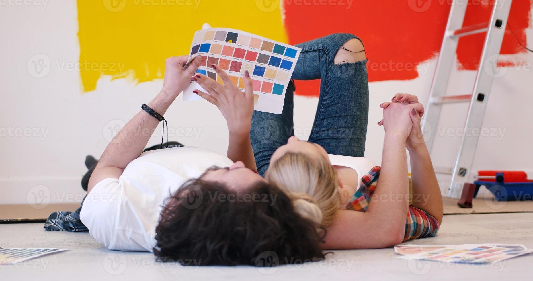 Happy young couple relaxing after painting photo