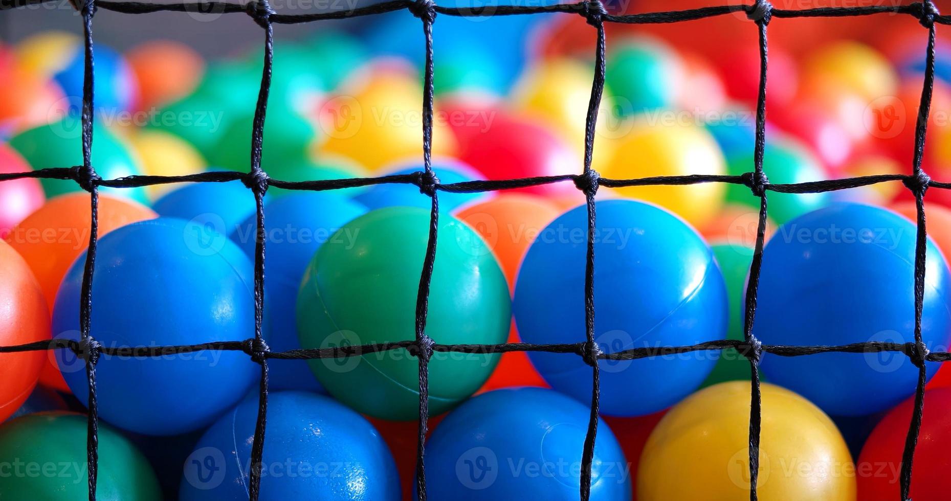 Colorful plastic toy balls in the play pool photo