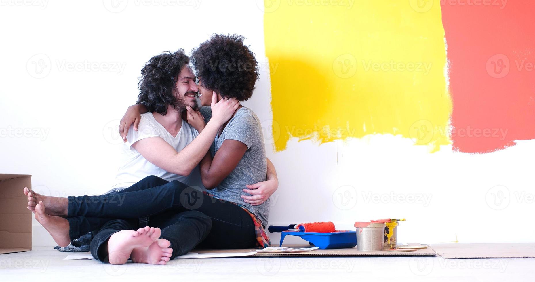 young multiethnic couple relaxing after painting photo