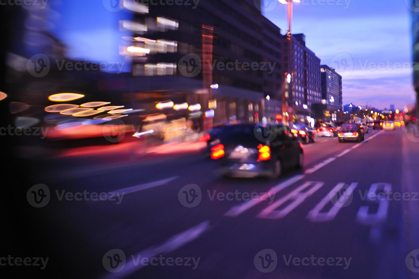 City night with cars motion blurred light in busy street photo