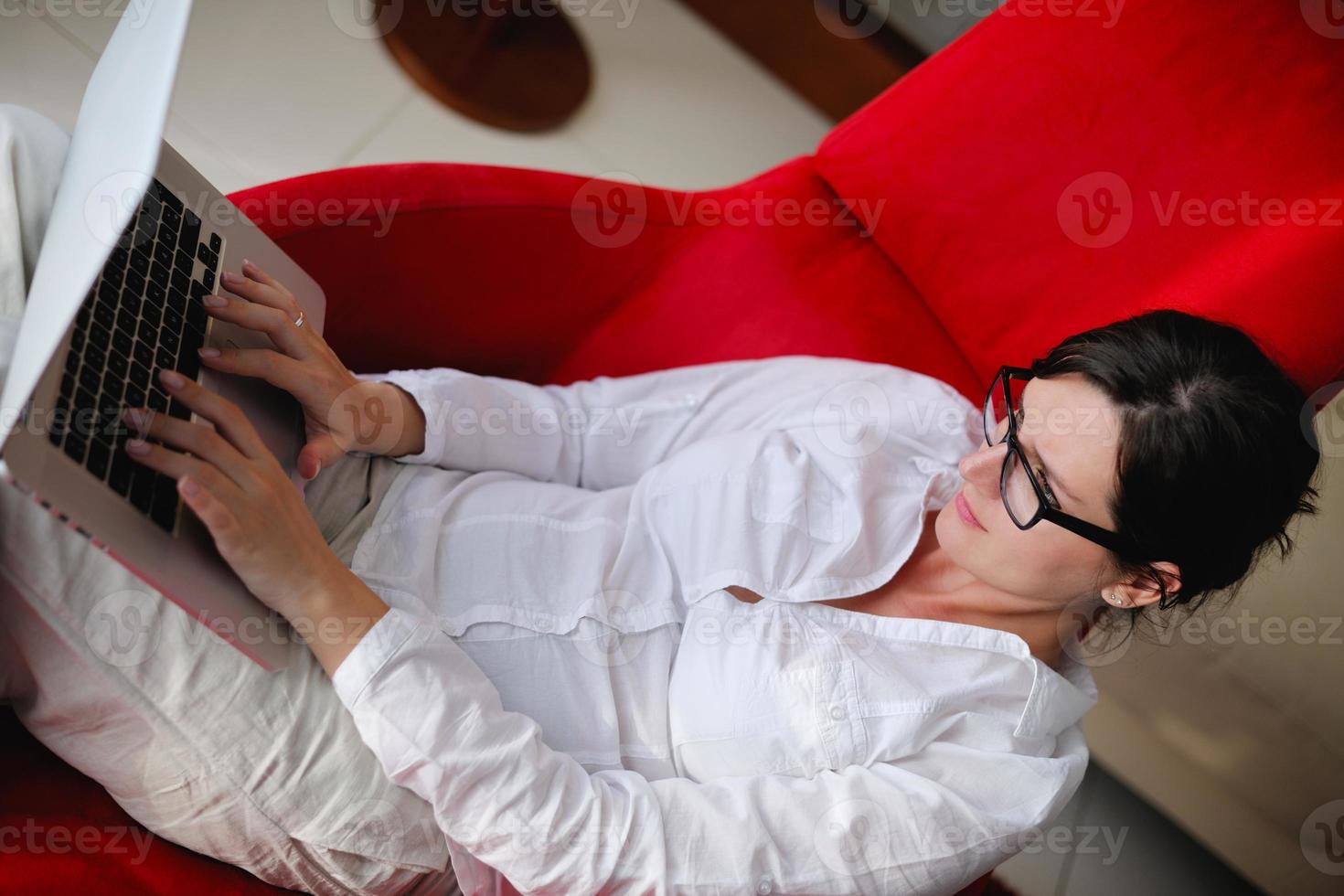 woman using a laptop computer at home photo