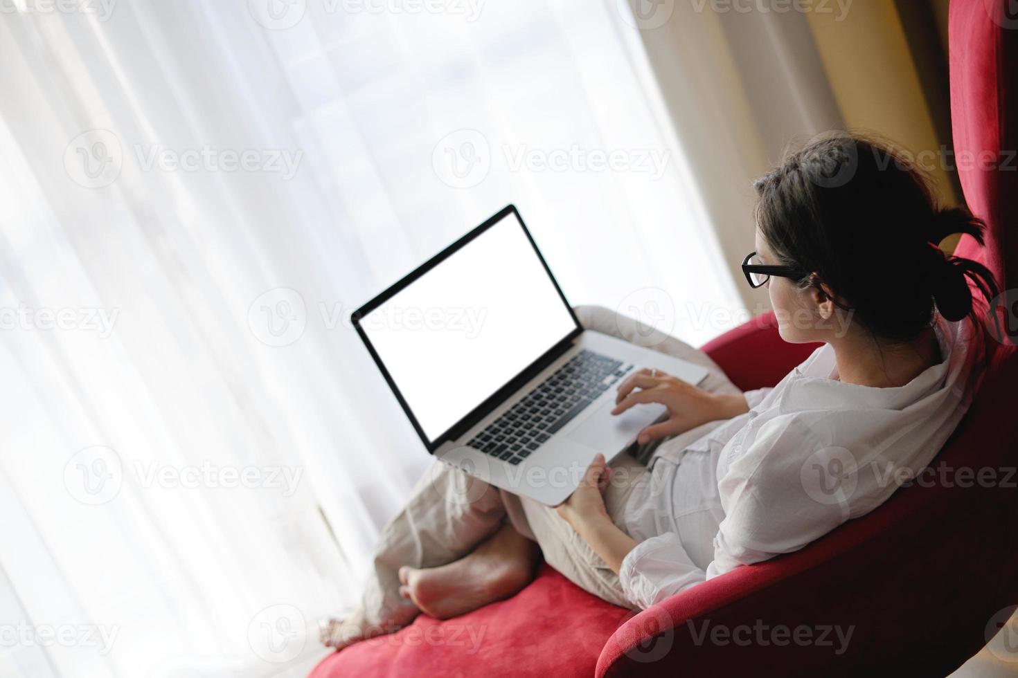 woman using a laptop computer at home photo