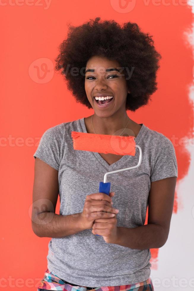 black woman painting wall photo