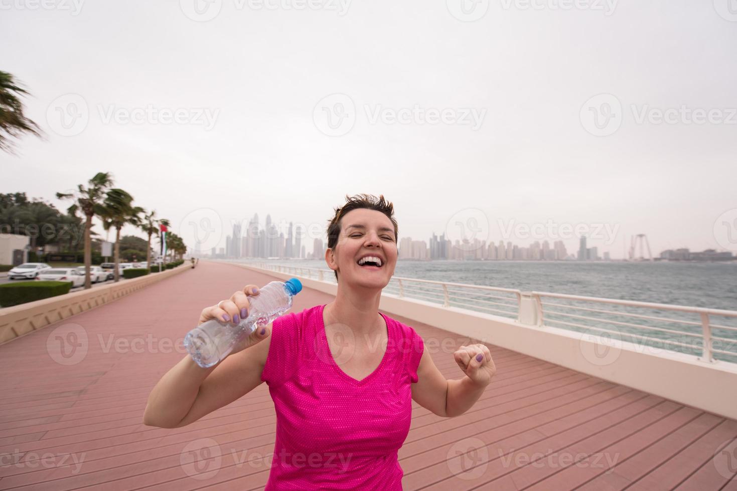 young woman celebrating a successful training run photo