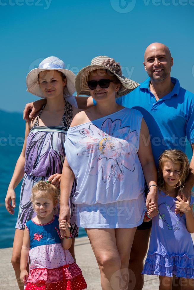 Portrait of happy multi generation family by the sea photo