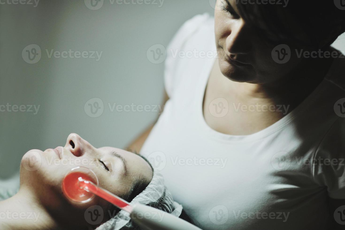 woman with facial mask in cosmetic studio photo