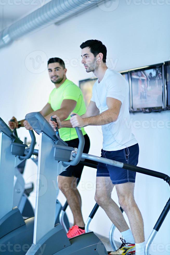 Group of people running on treadmills photo