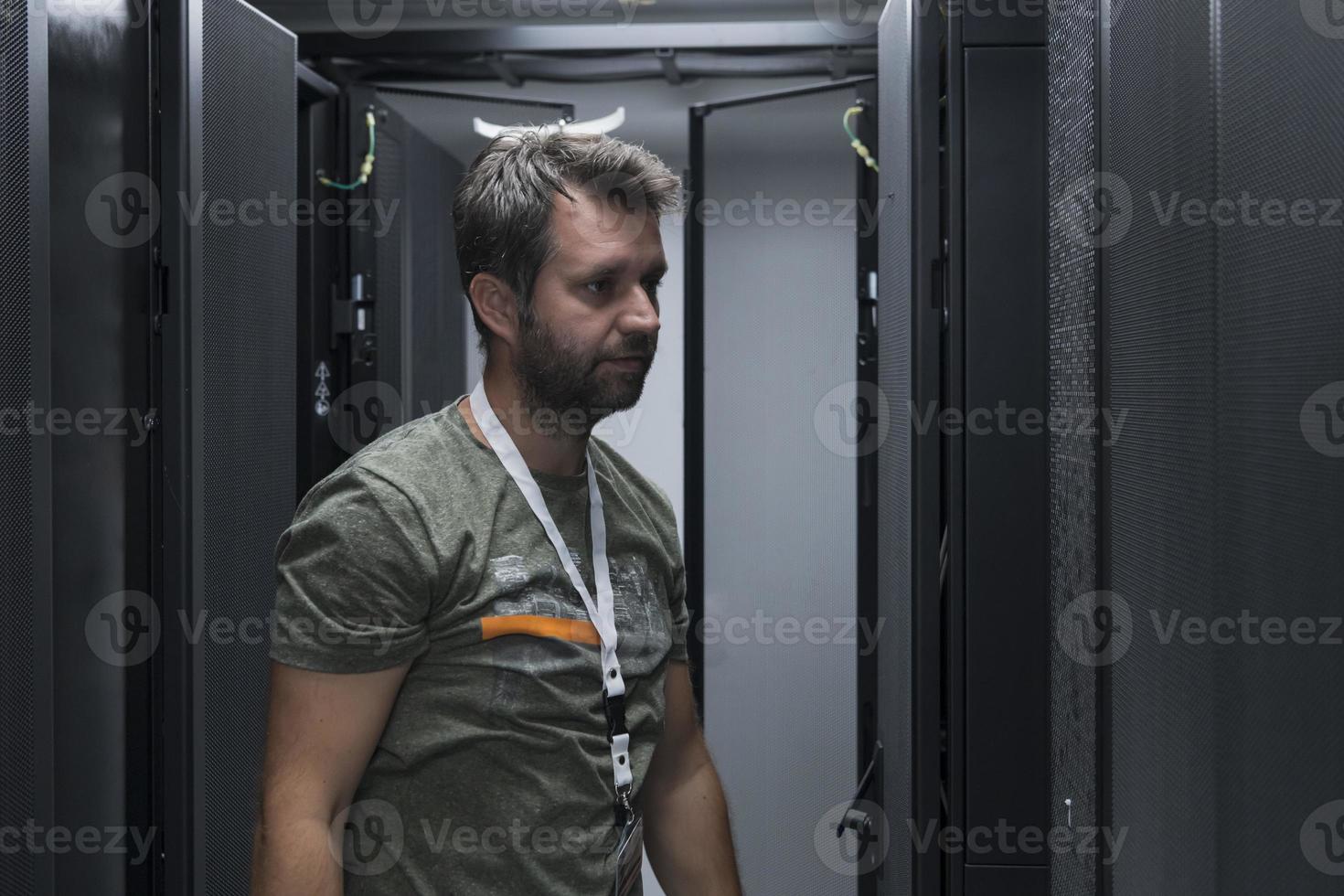 IT engineer working In the server room or data center The technician puts in a rack a new server of corporate business mainframe supercomputer or cryptocurrency mining farm. photo