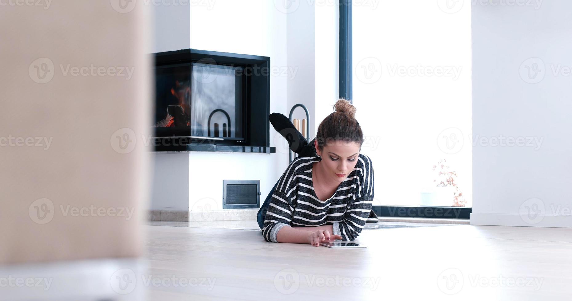 young women using tablet computer on the floor photo