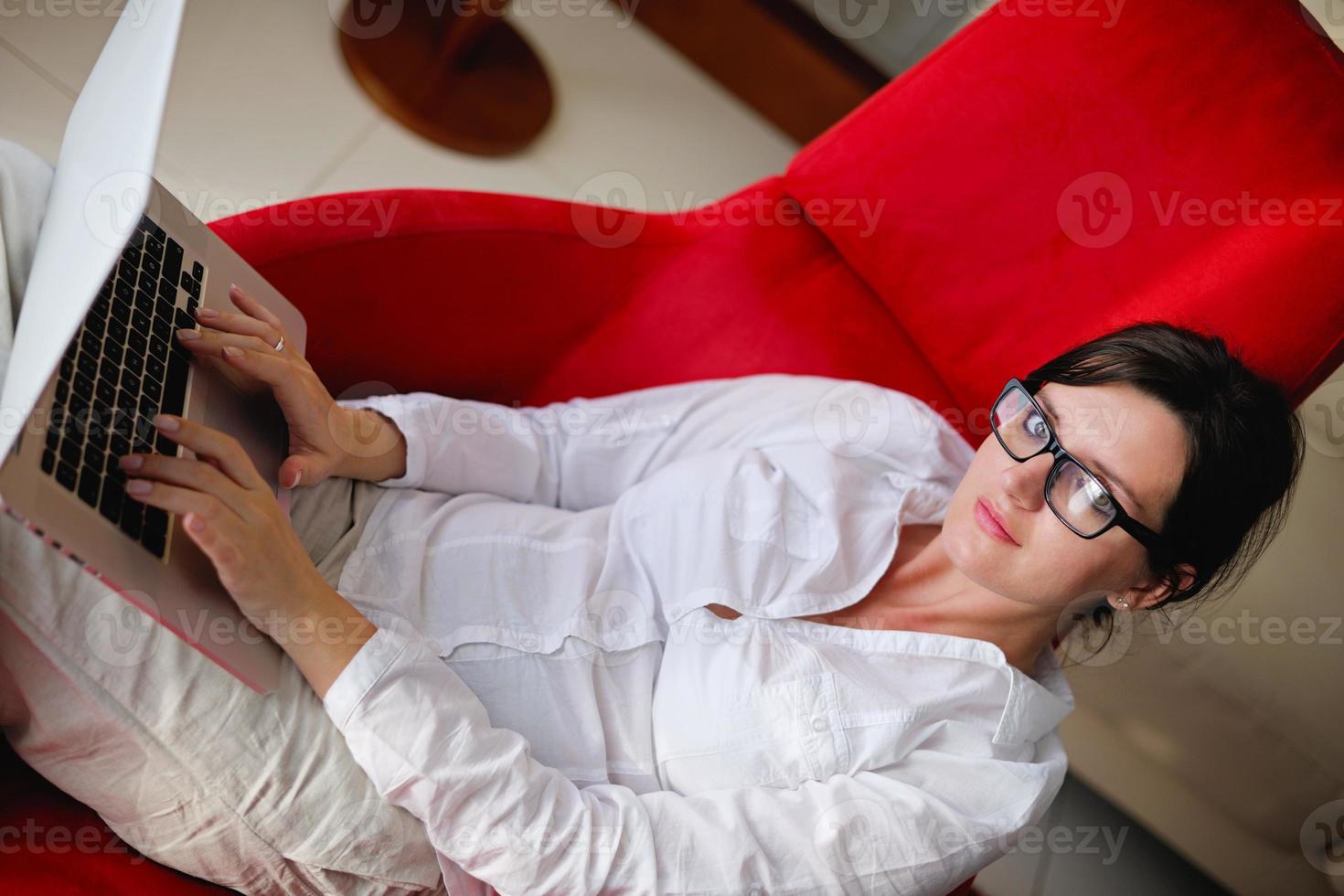 woman using a laptop computer at home photo