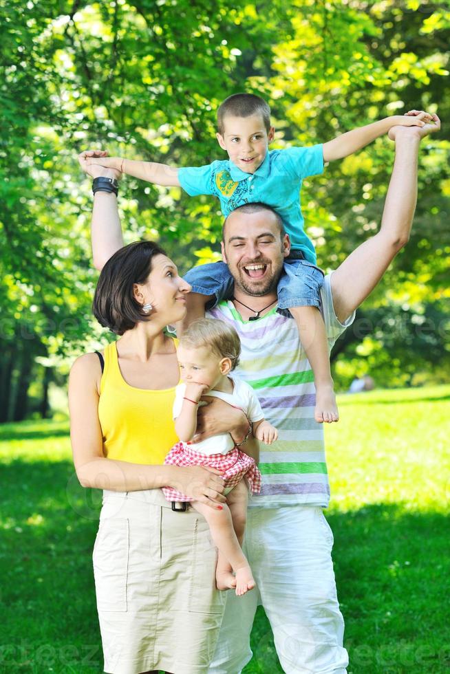 happy young couple with their children have fun at park photo