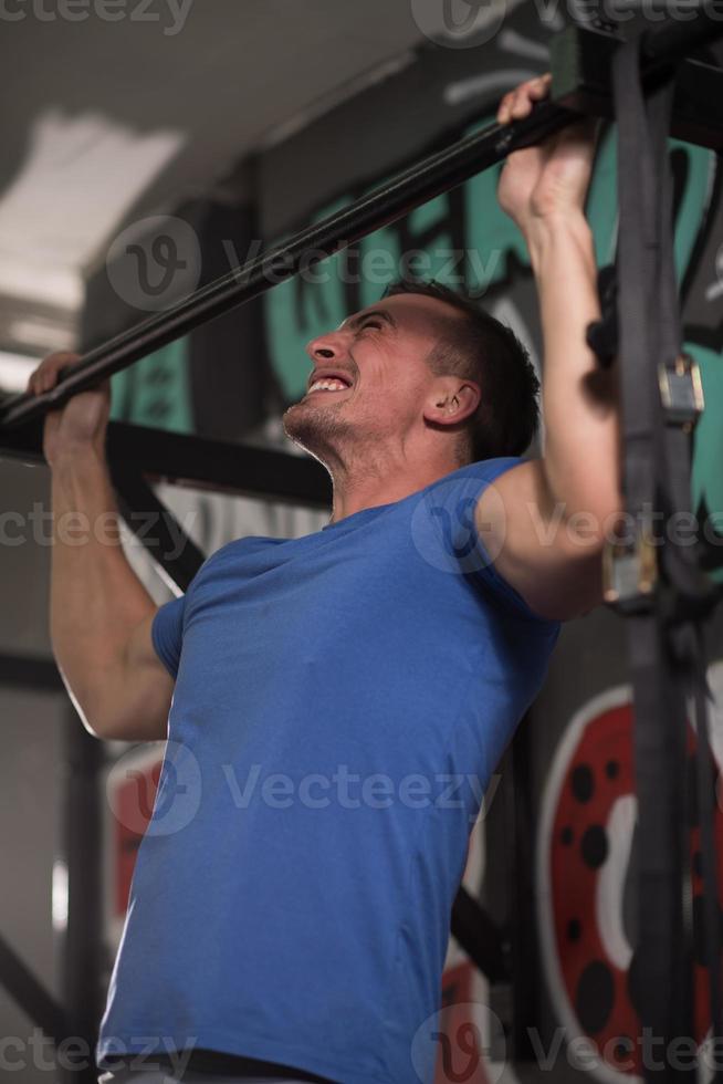 man doing pull ups photo