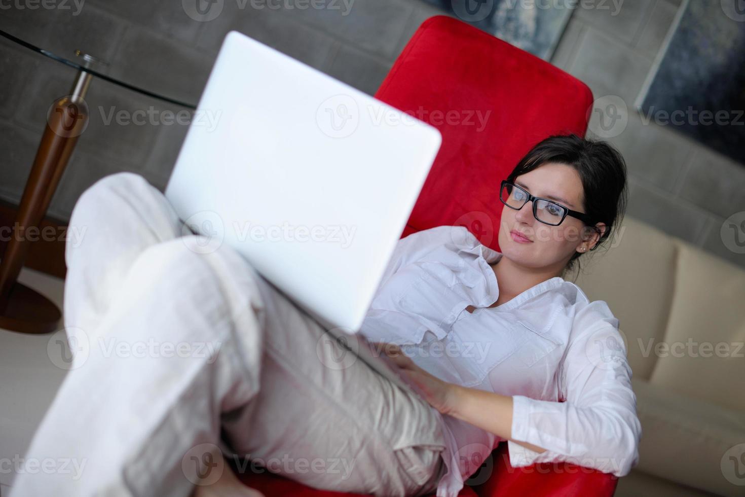 woman using a laptop computer at home photo