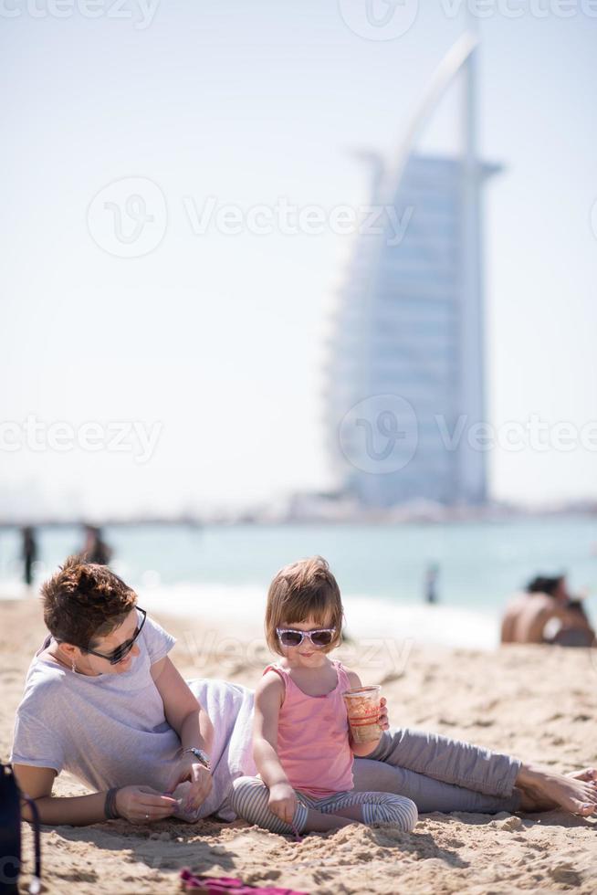 Mom and daughter on the beach photo