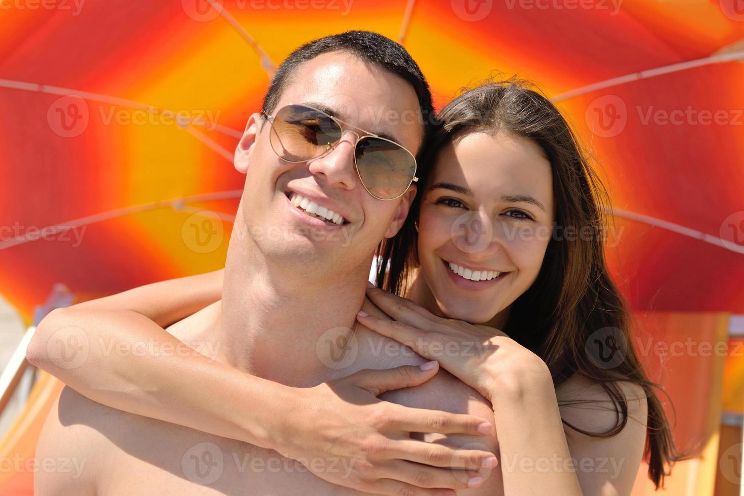 happy couple have fun on the beach photo