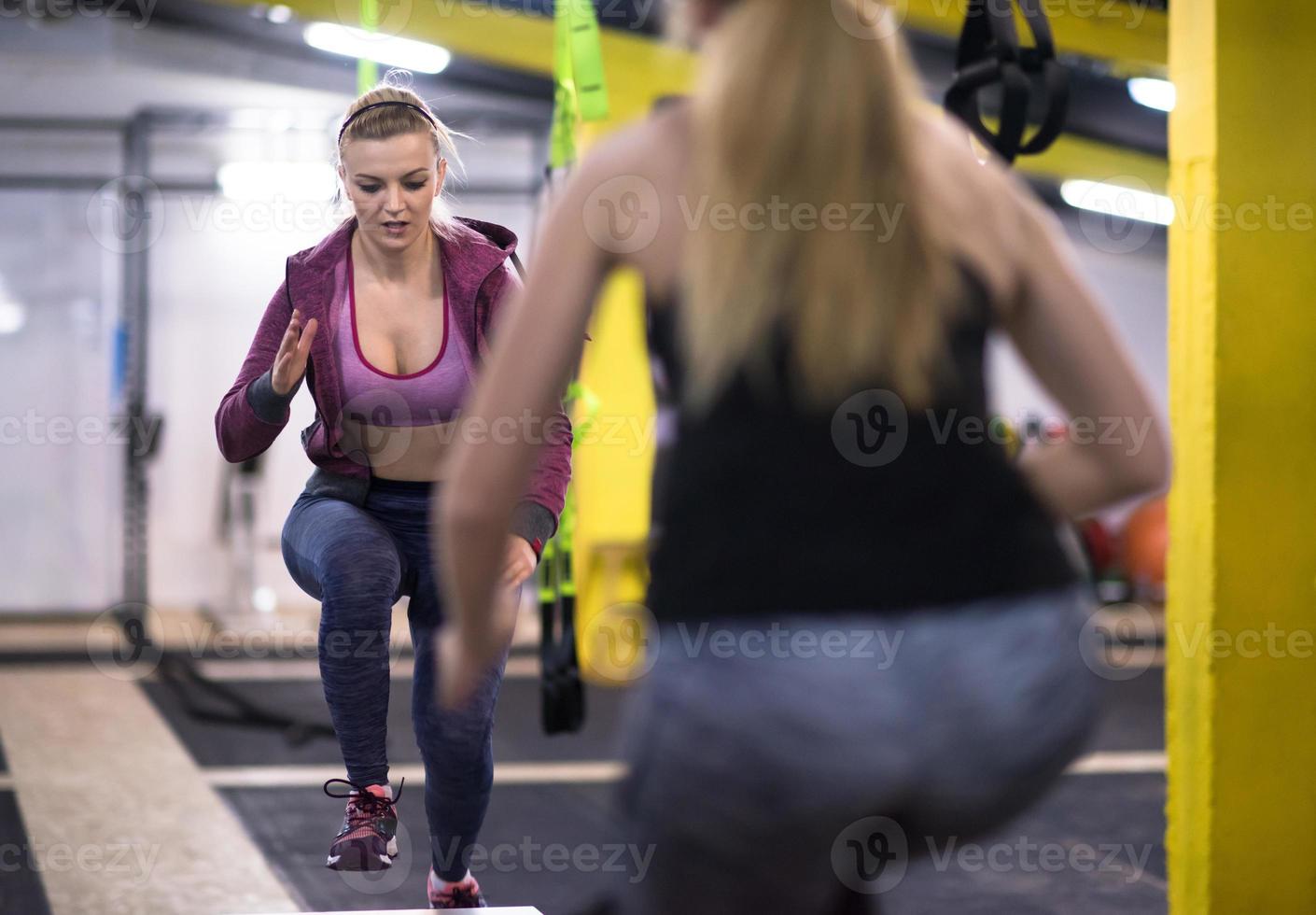 athletes working out  jumping on fit box photo