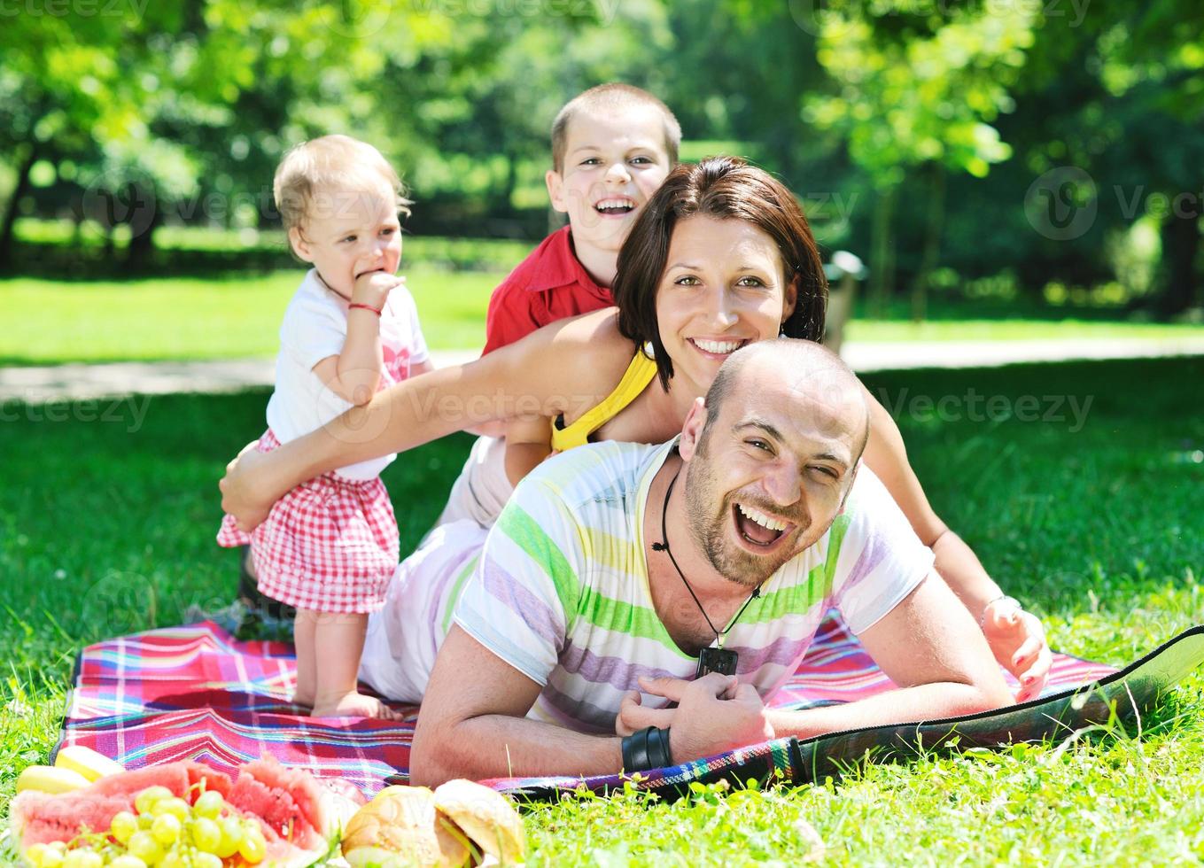 happy young couple with their children have fun at park photo