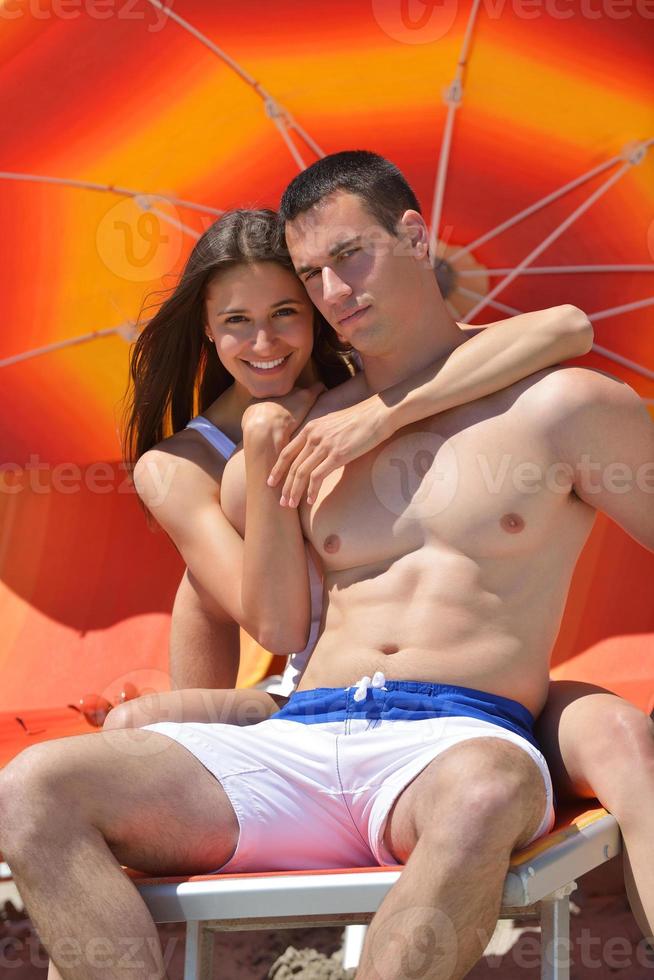 happy young couple have fun on beach photo