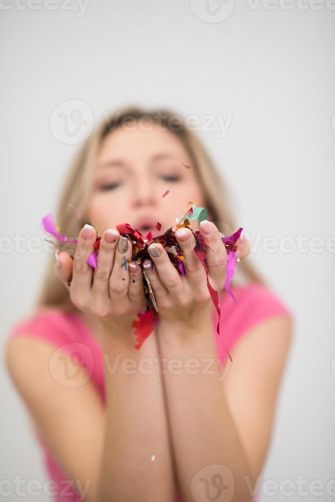 woman blowing confetti in the air photo