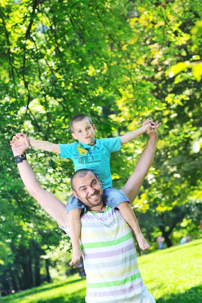 happy father and son have fun at park photo