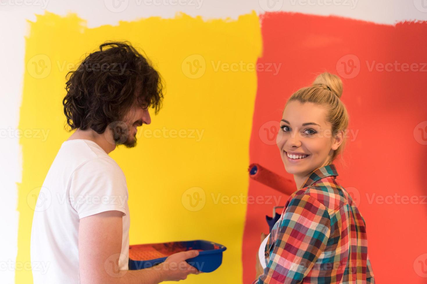 couple painting interior wall photo