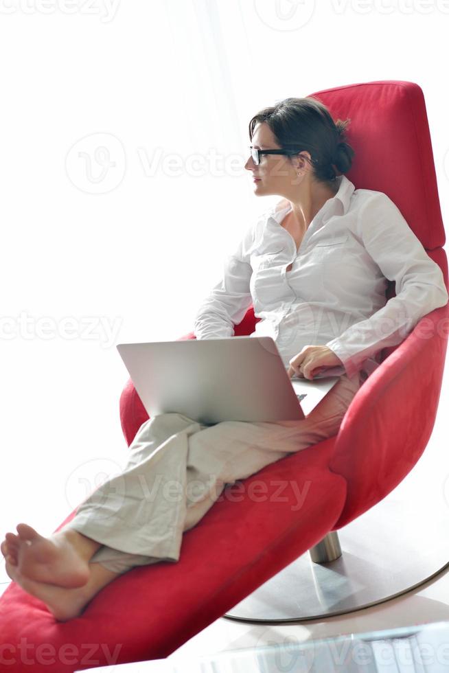 woman using a laptop computer at home photo