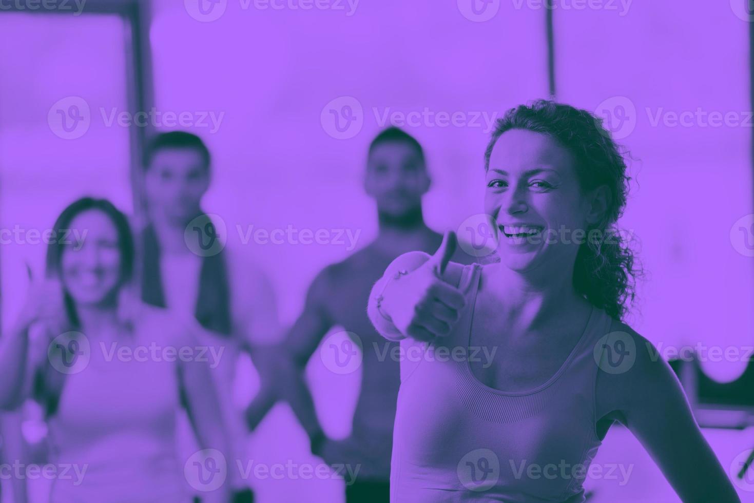 Group of people exercising at the gym photo