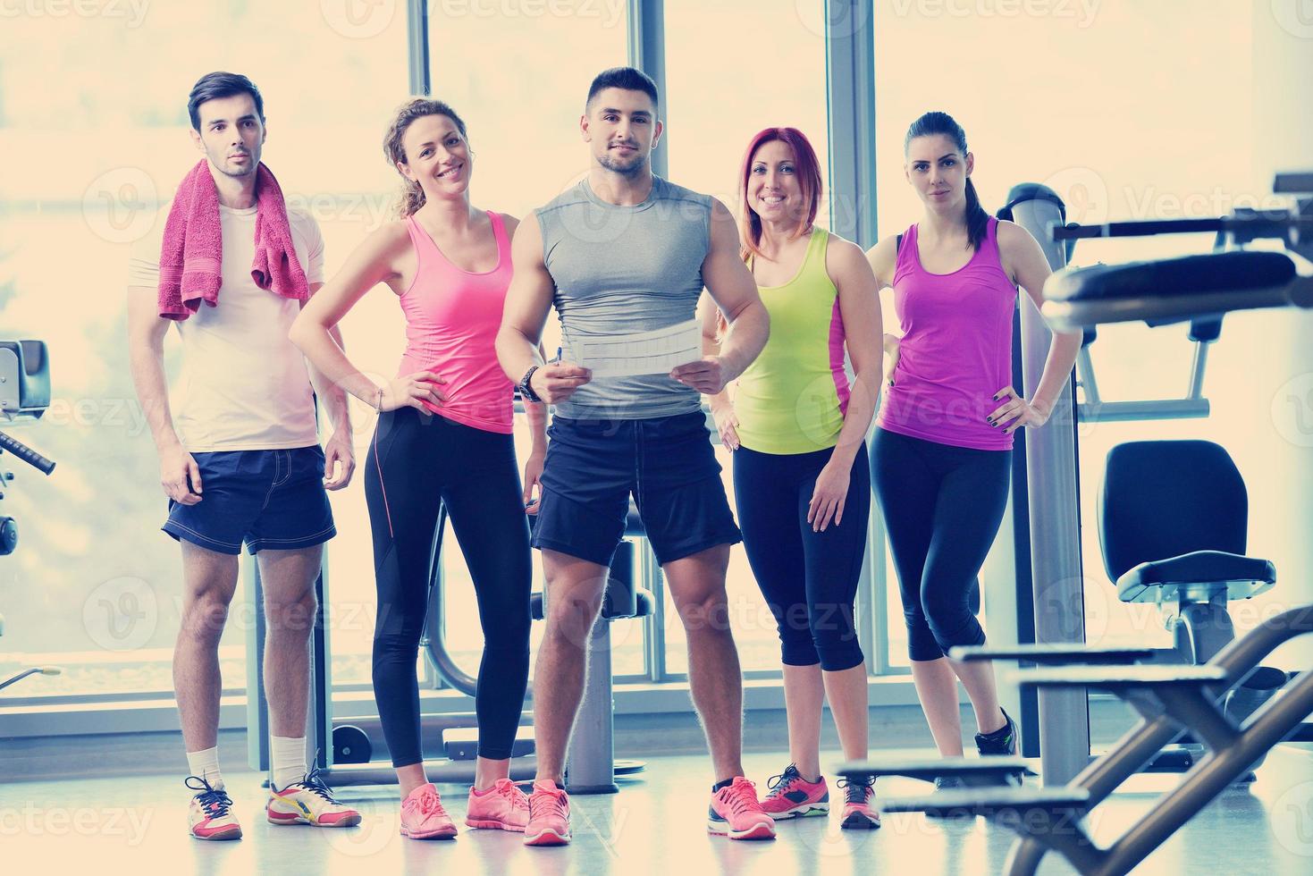 Group of people exercising at the gym photo