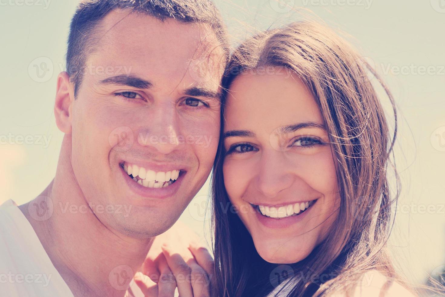 happy couple have fun on the beach photo
