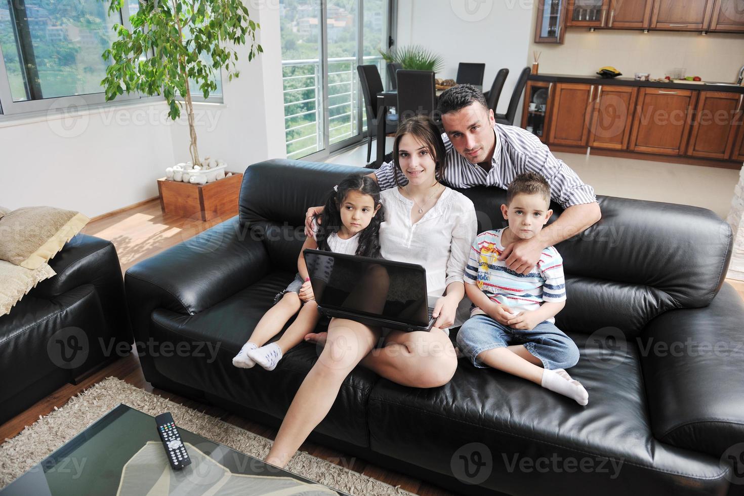 happy young family have fun and working on laptop at home photo