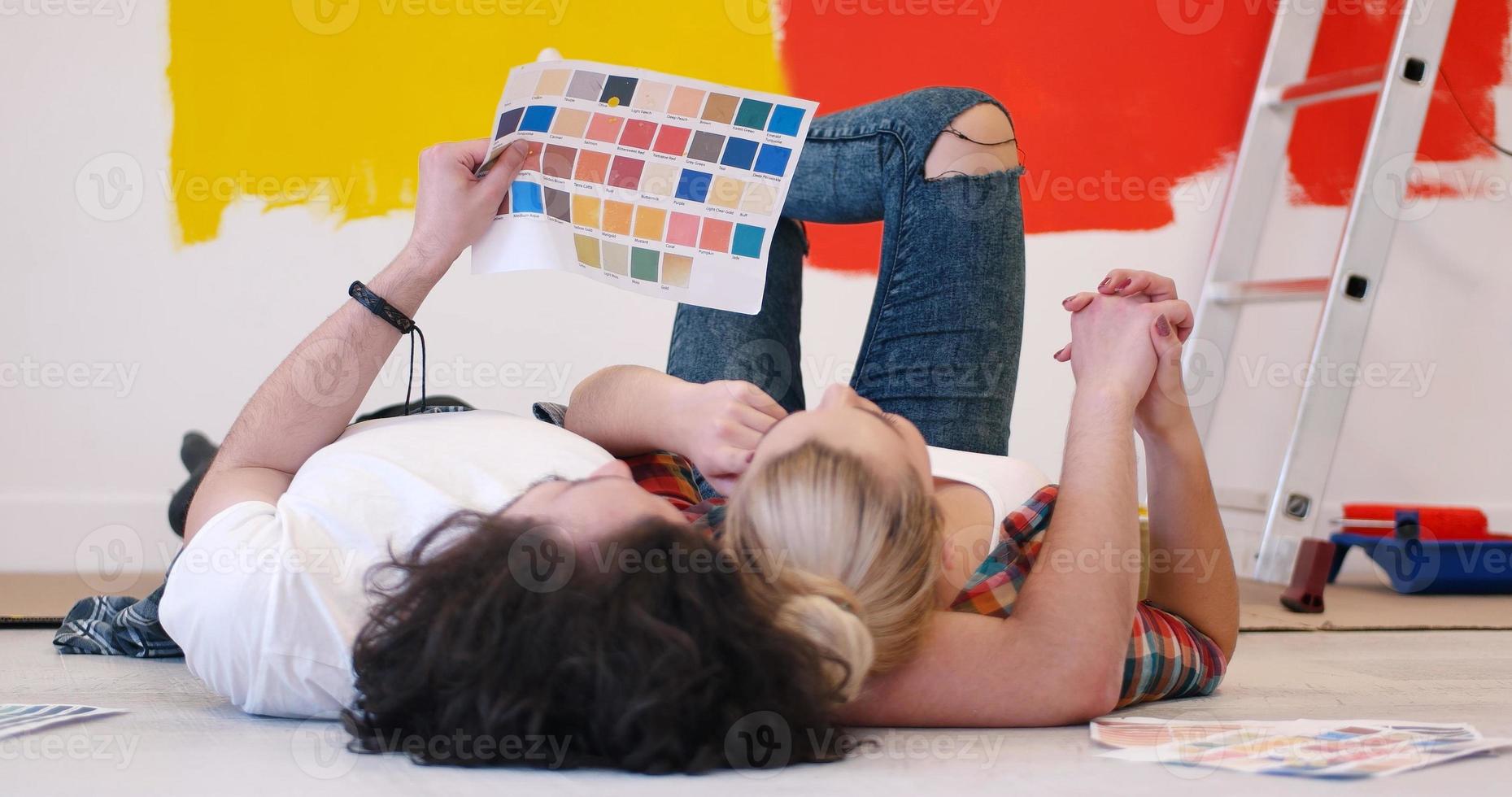 Happy young couple relaxing after painting photo