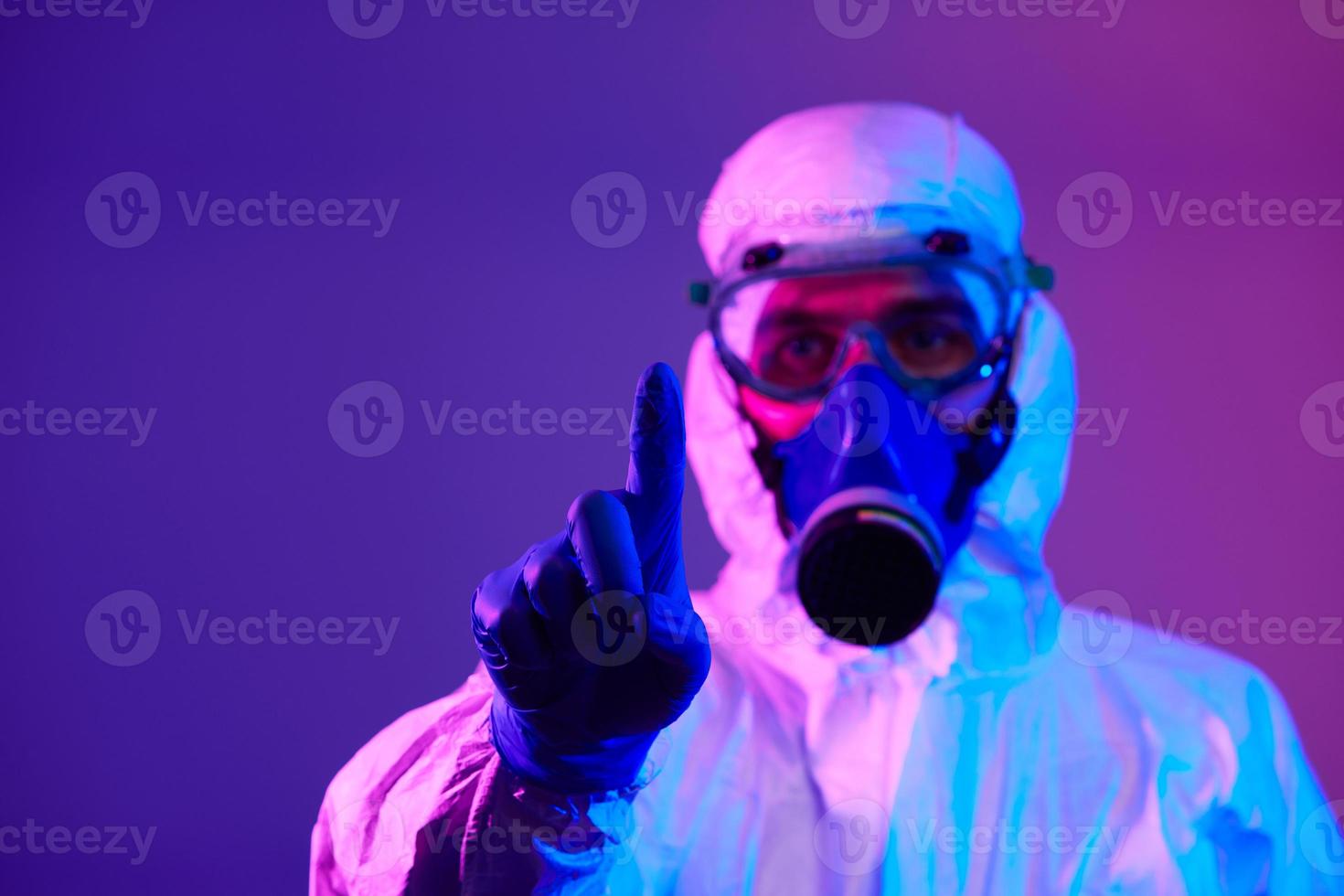 Doctor wearing protective biological suit and mask due to coronavirus photo