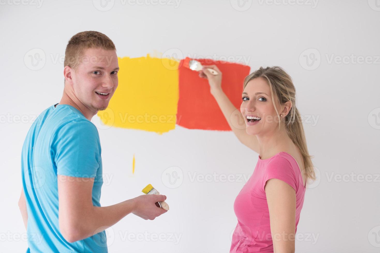 couple painting interior wall photo