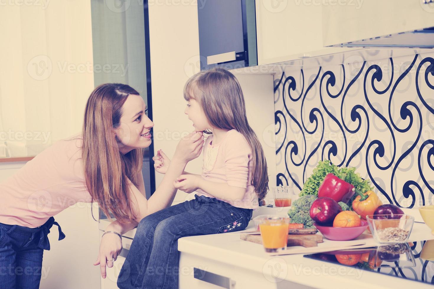 happy daughter and mom in kitchen photo