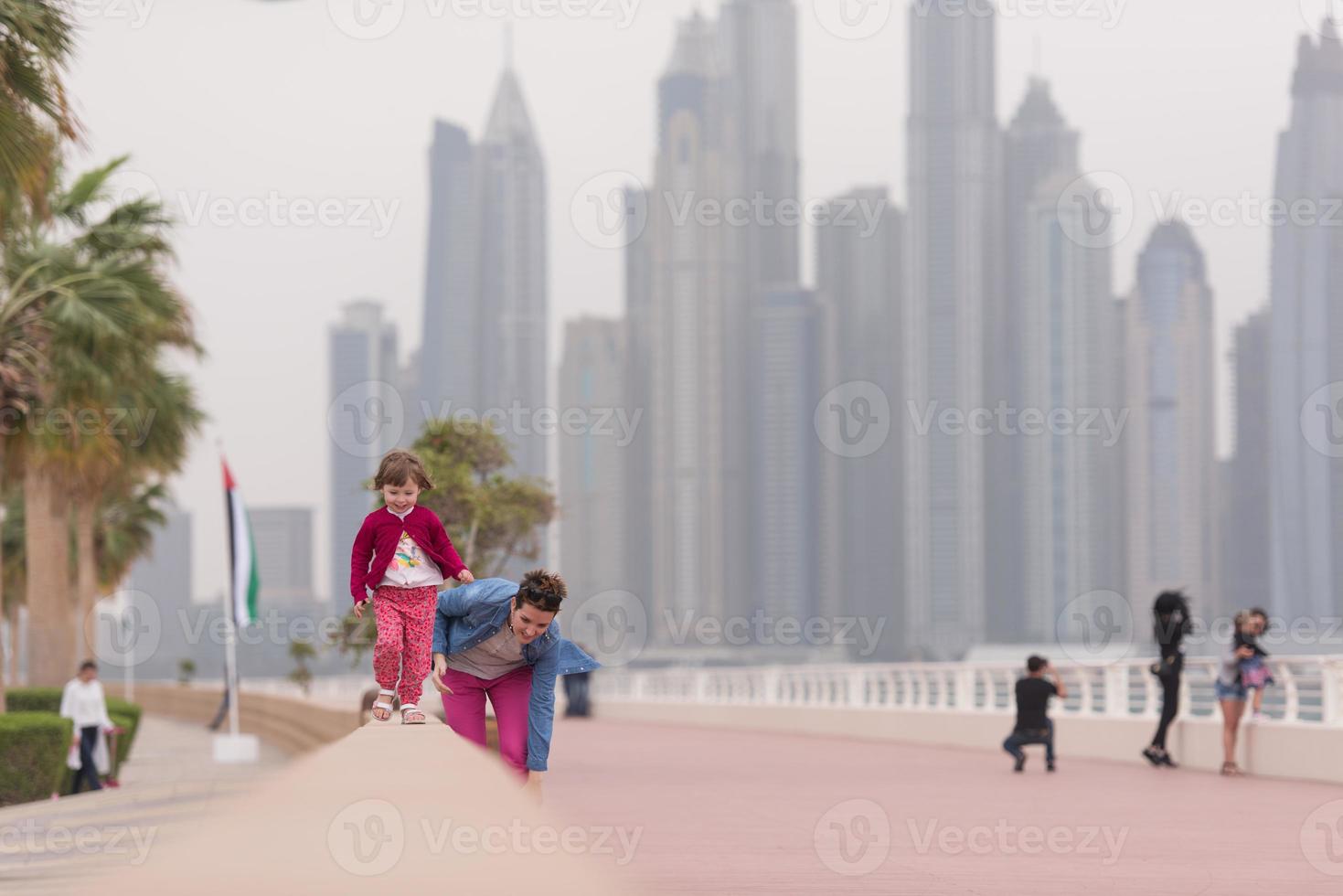 mother and cute little girl on the promenade photo