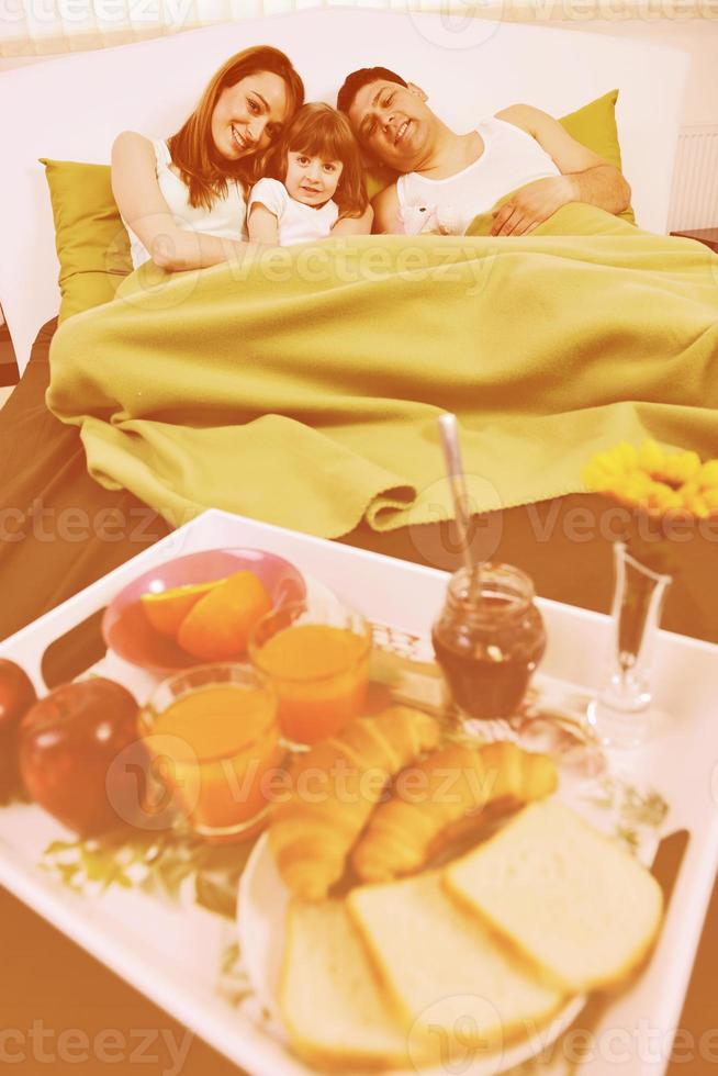 happy young family eat breakfast in bed 11300943 Stock Photo at Vecteezy