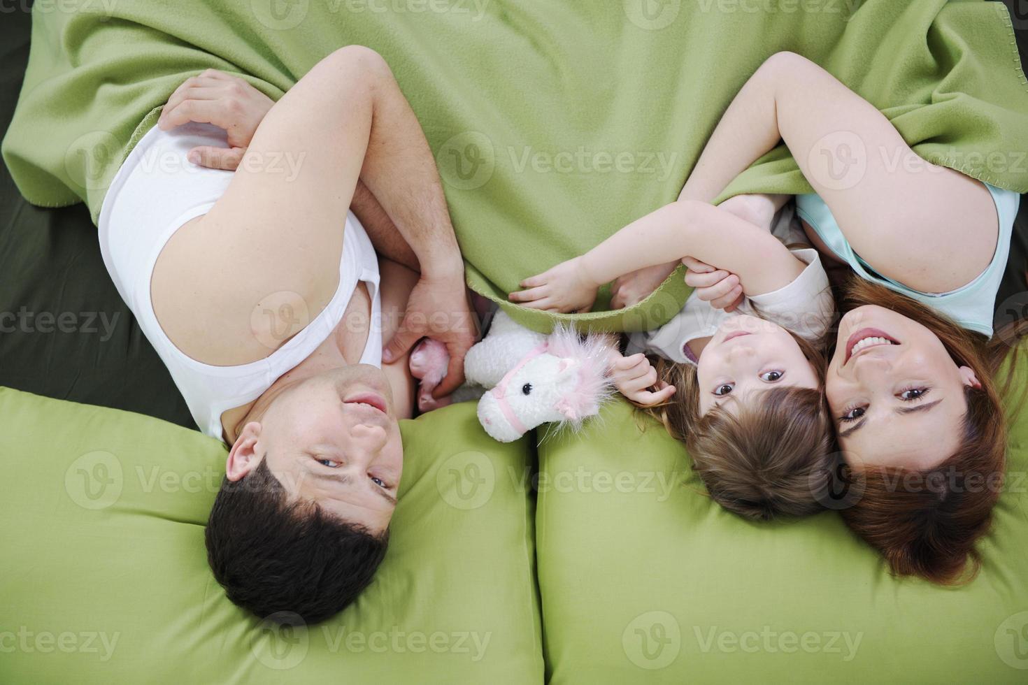 happy family relaxing in bed photo