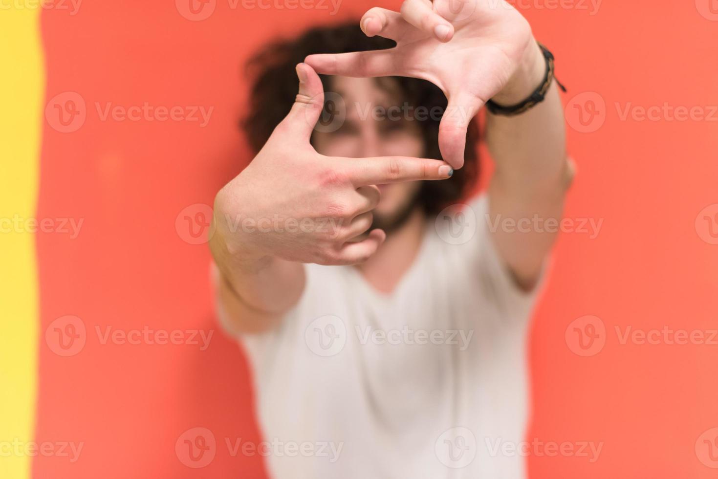 young man with funny hair over color background photo