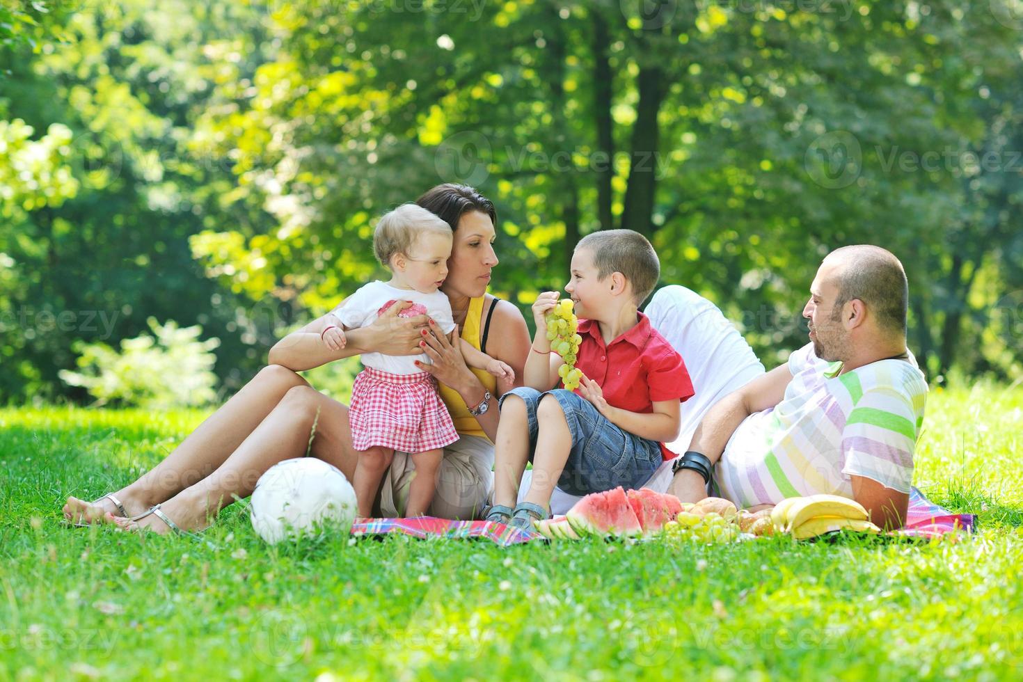 happy young couple with their children have fun at park photo