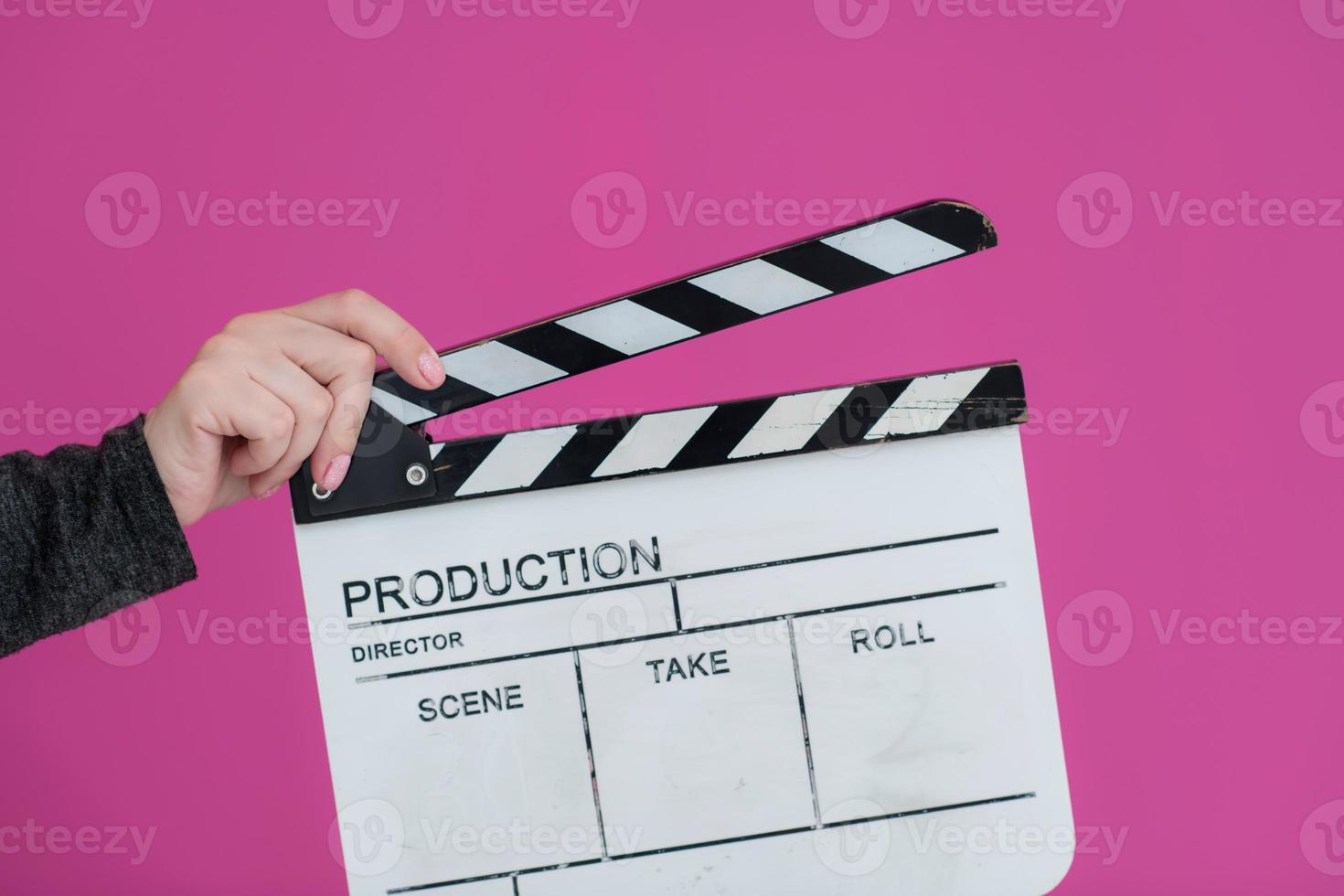 movie clapper on pink background photo