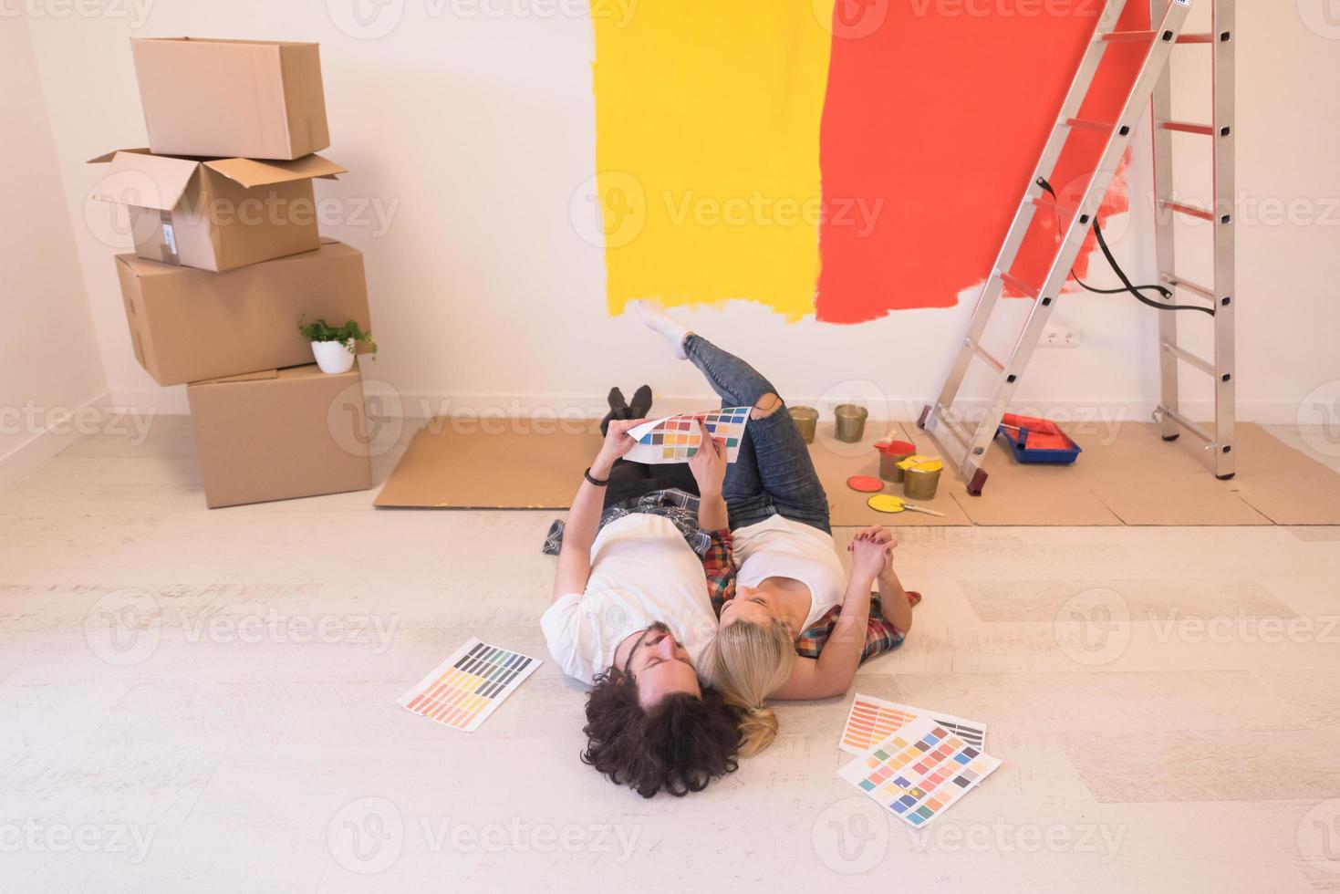 Happy young couple relaxing after painting photo