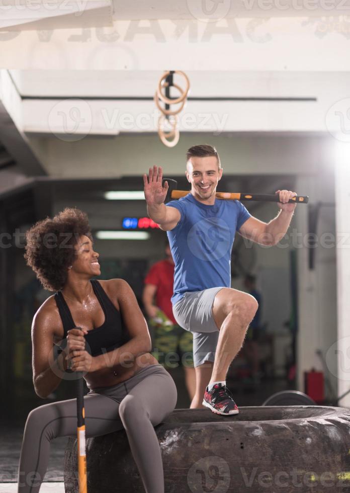 multiethnic couple after workout with hammer photo