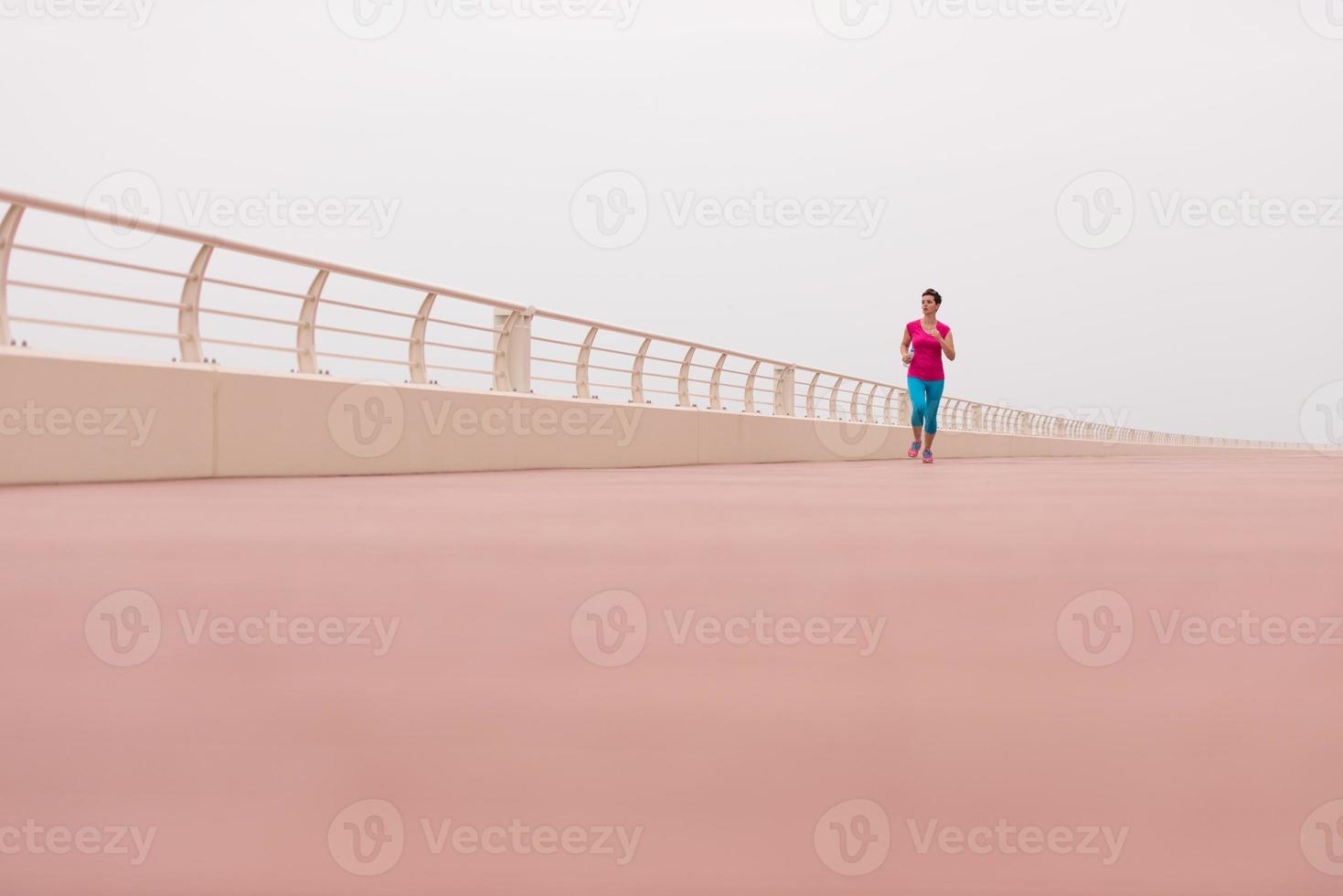 woman busy running on the promenade photo