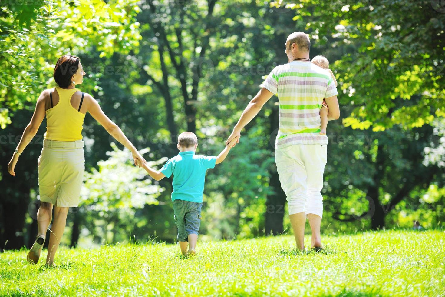 happy young couple with their children have fun at park photo