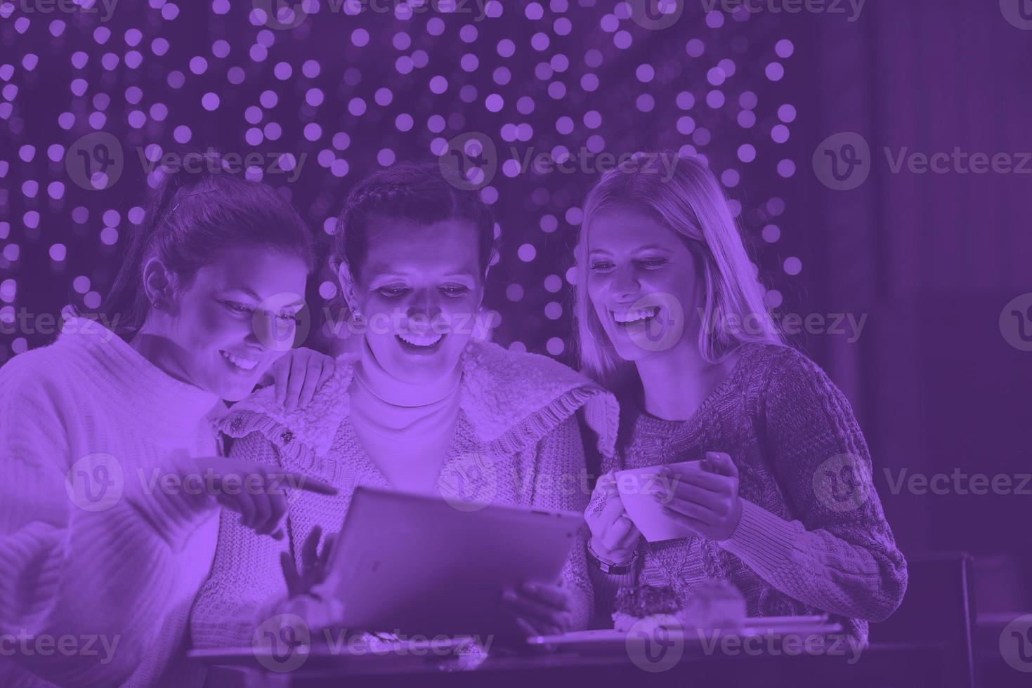 happy girls group  looking at a pc tablet photo