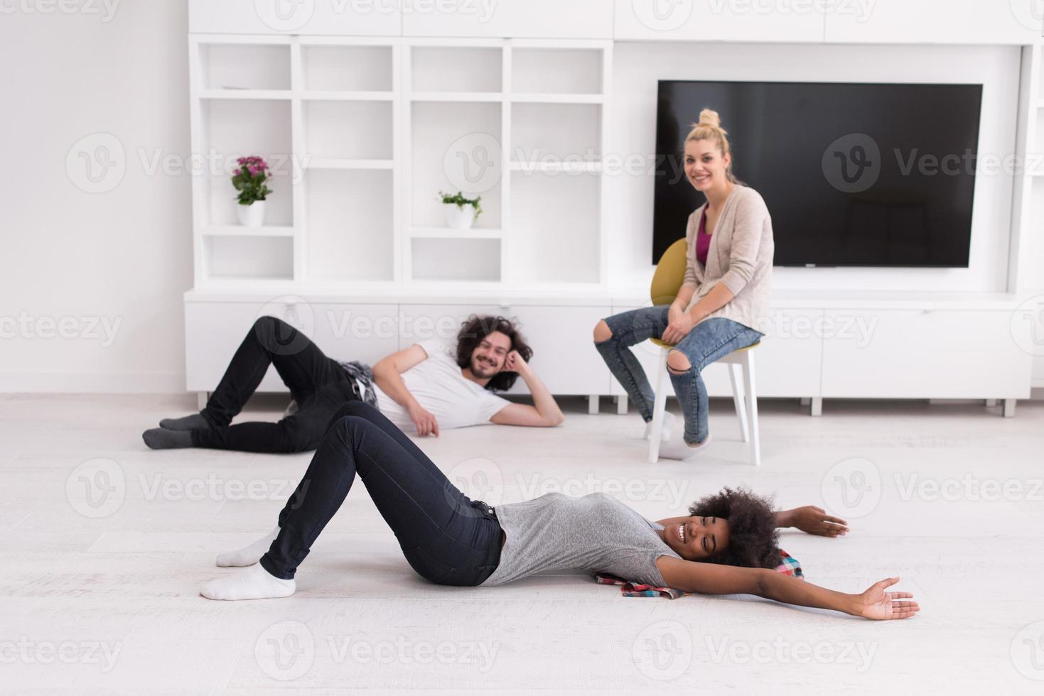 multiethnic group of people relax in their new apartment photo