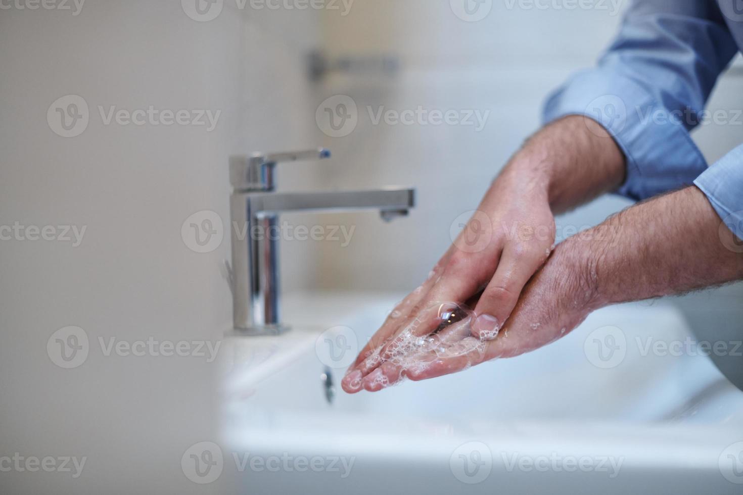 coronavirus male wahing hands in bathroom photo