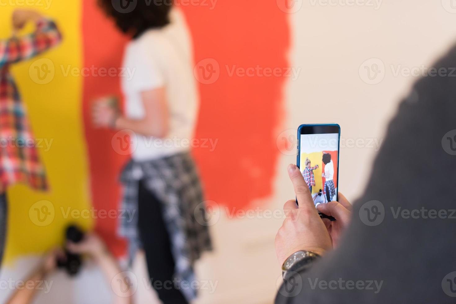 couple painting interior wall photo