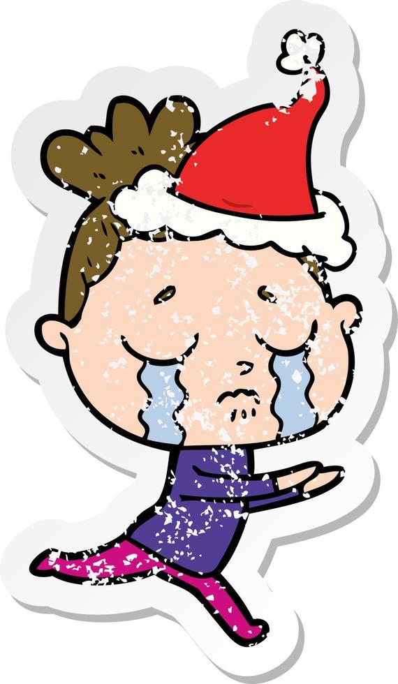 distressed sticker cartoon of a crying woman wearing santa hat vector