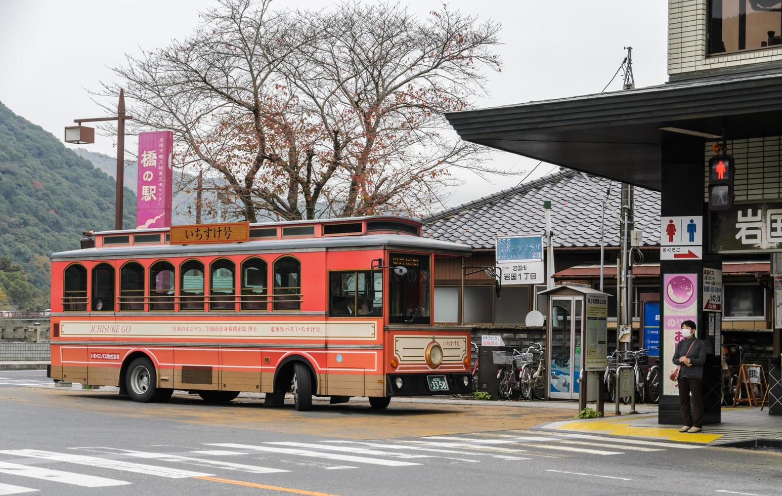 IWAKUNI, JAPAN - NOVEMBER 21, 2016 Japanese train type retro bus ICHISUKE at kintai-kyo bus stop in Iwakuni, Japan. The bus ICHISUKE travel from Iwakuni station to Kintai-kyo station. photo